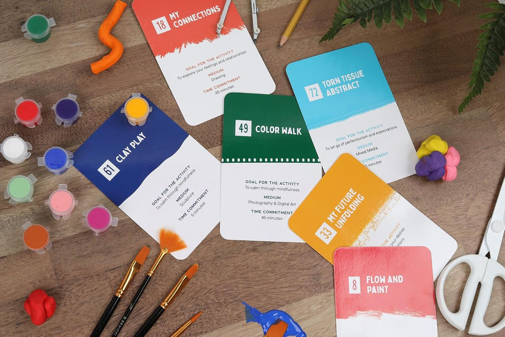 Colorful art supplies and cards on a wooden surface