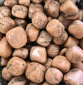 A pile of tumbled peach moonstone