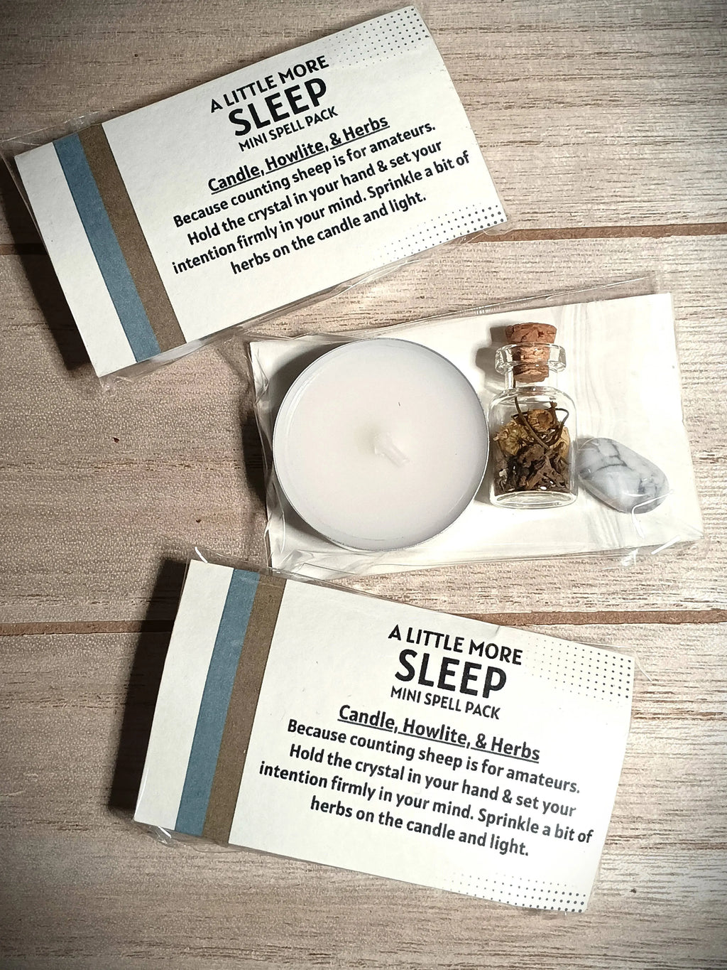 Sleep spell pack with candle, crystal, and herbs on a wooden surface