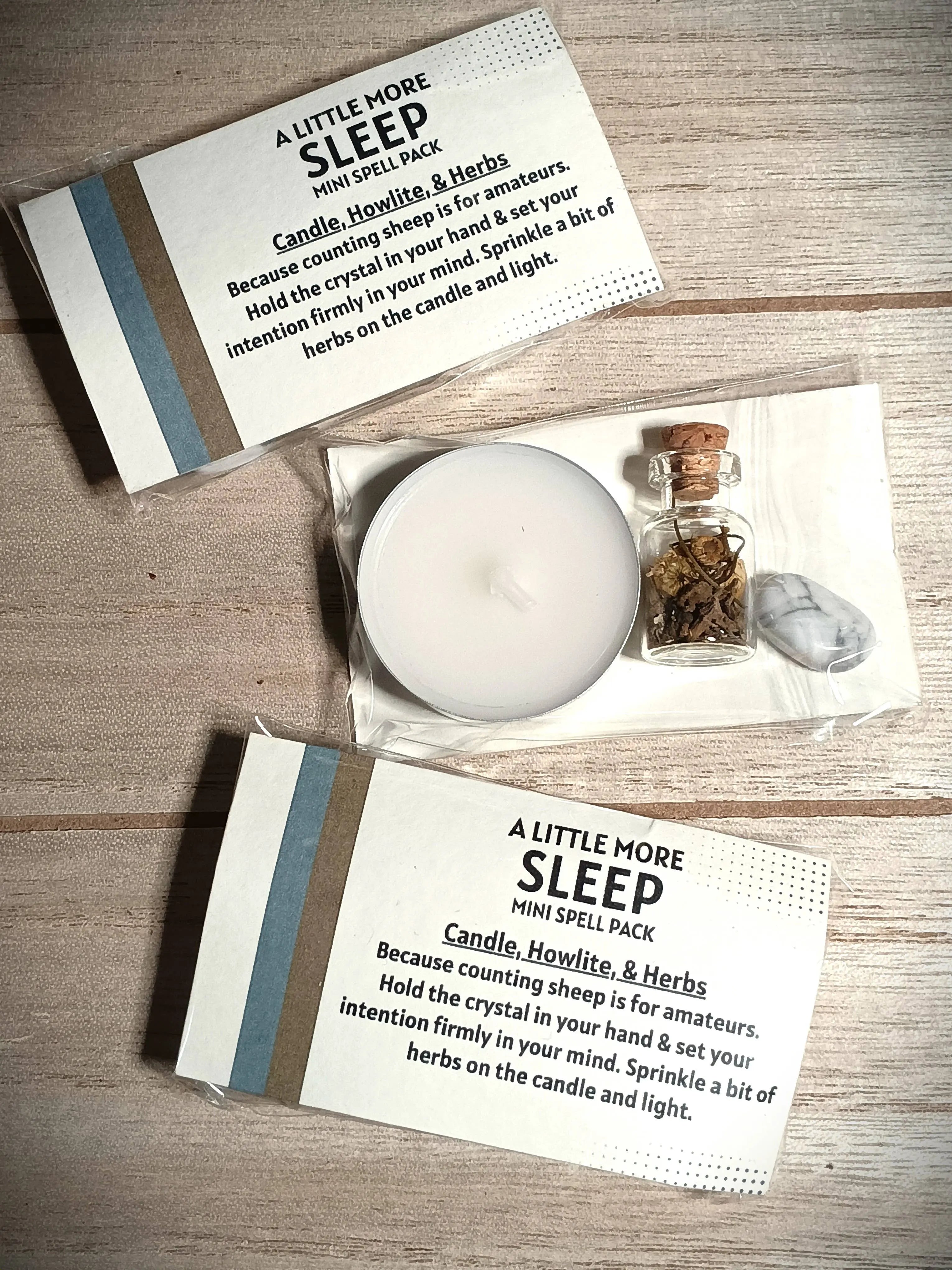 Sleep spell pack with candle, crystal, and herbs on a wooden surface