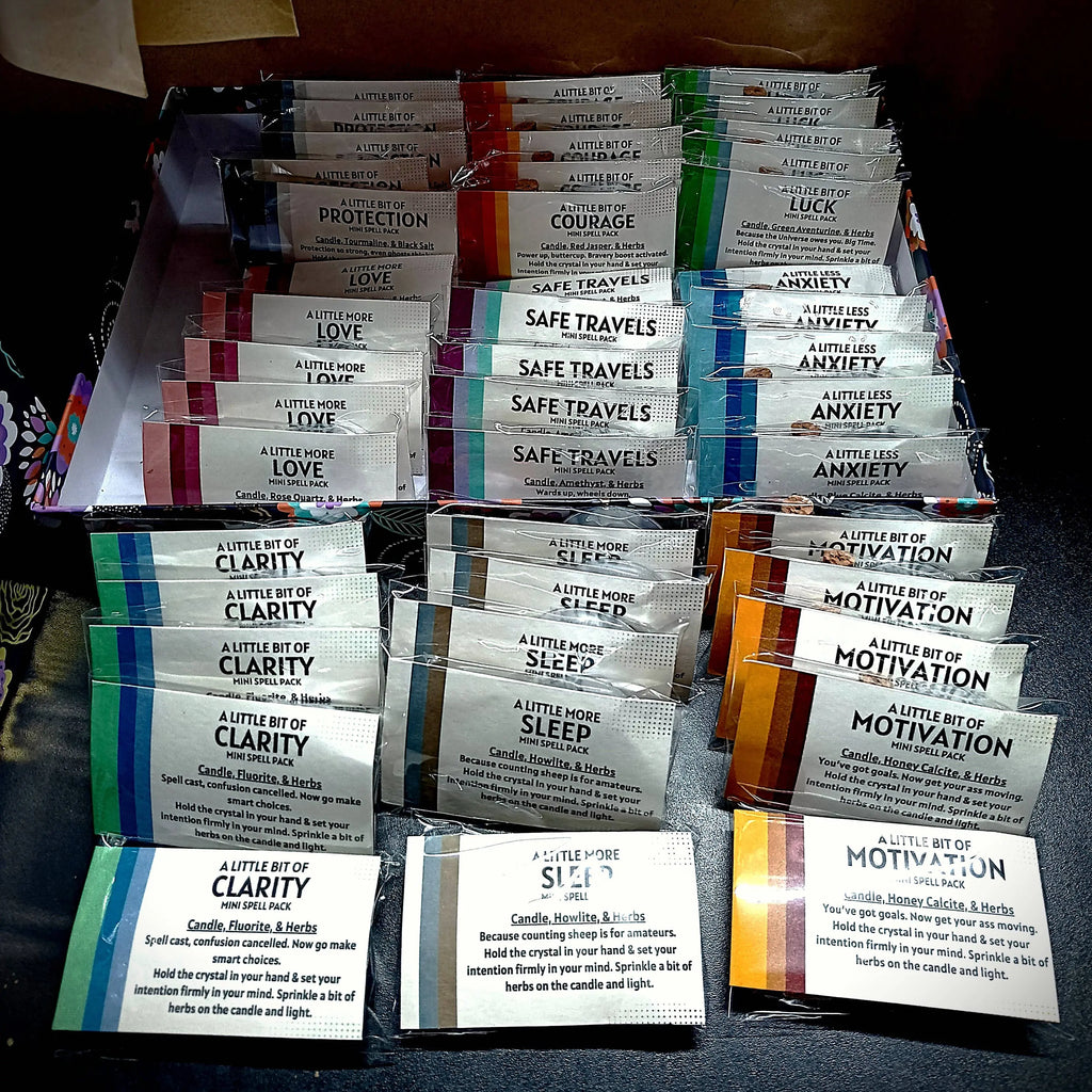Collection of small cards with various messages and colors on a dark surface.