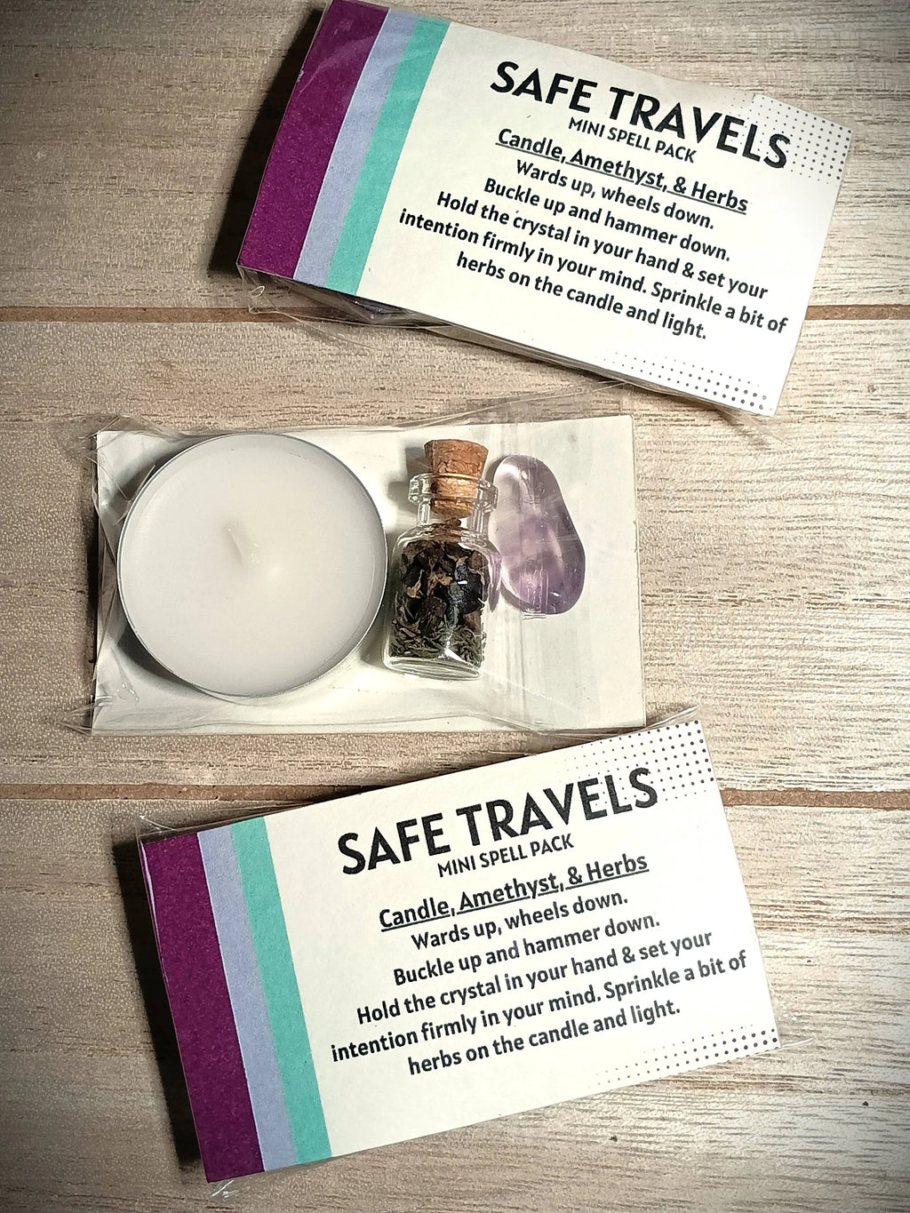 Safe Travels mini spell pack with candle, amethyst crystal, and herbs on a wooden surface.