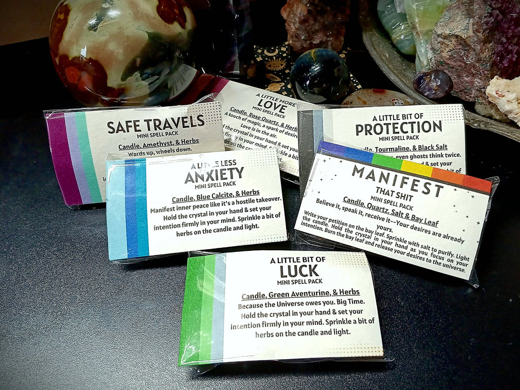 Set of mini spell packs with text on a dark surface