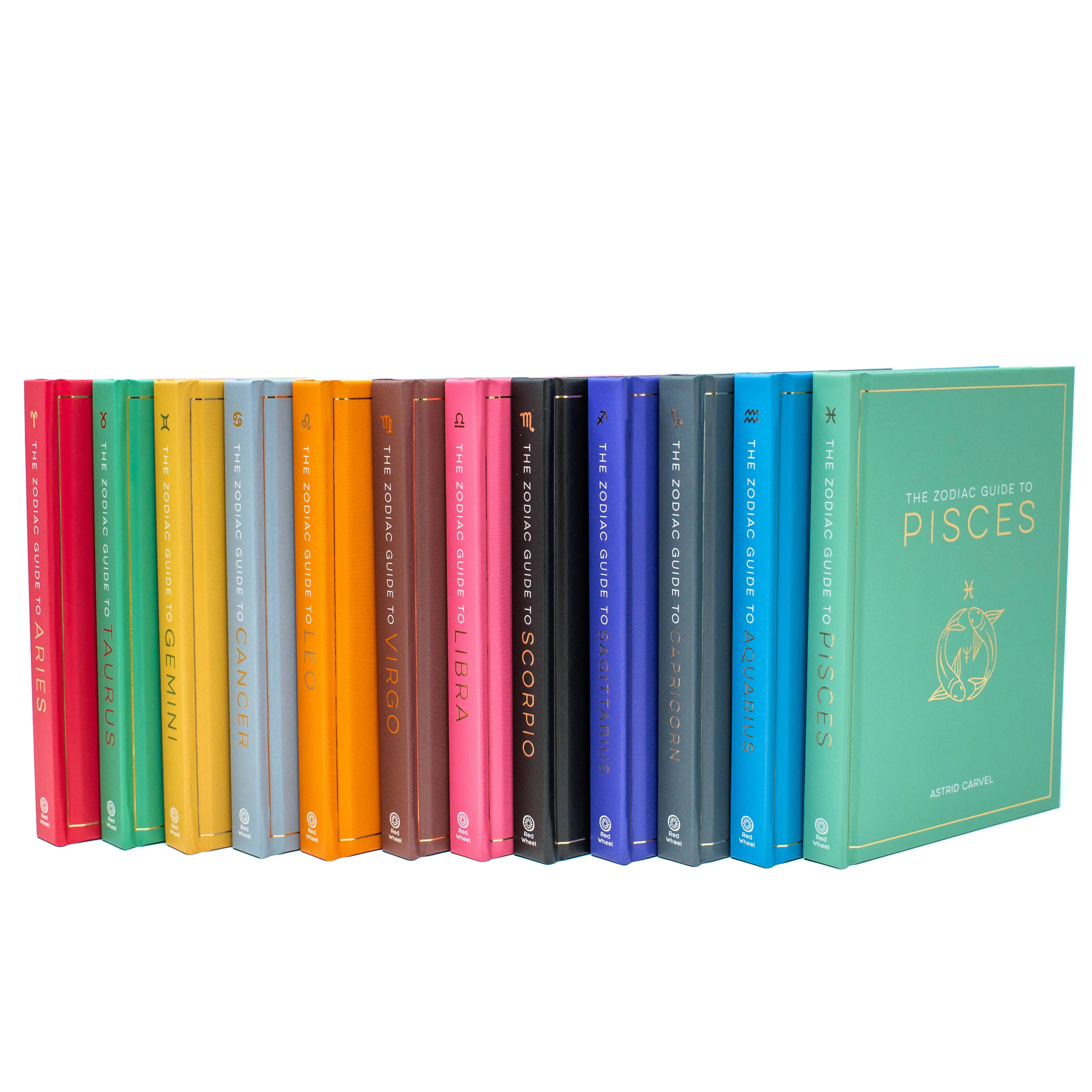 Set of colorful books titled 'The Zodiac Guide' on a white background