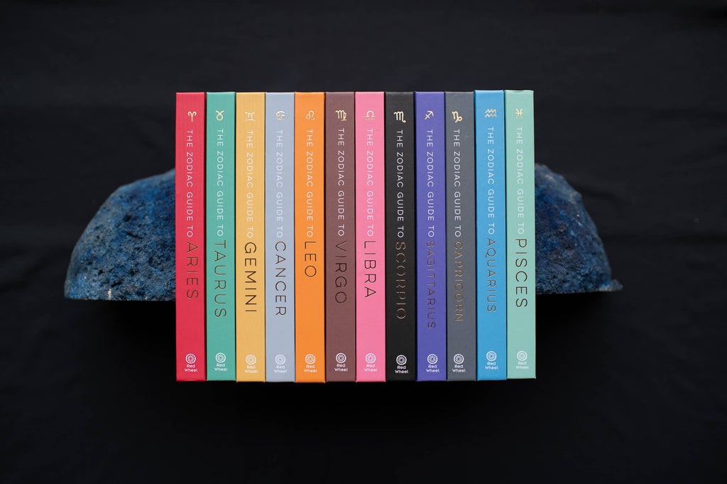 Set of books titled 'The Zodiac Guide to Astrology' by Astrid Carvel on a dark background.