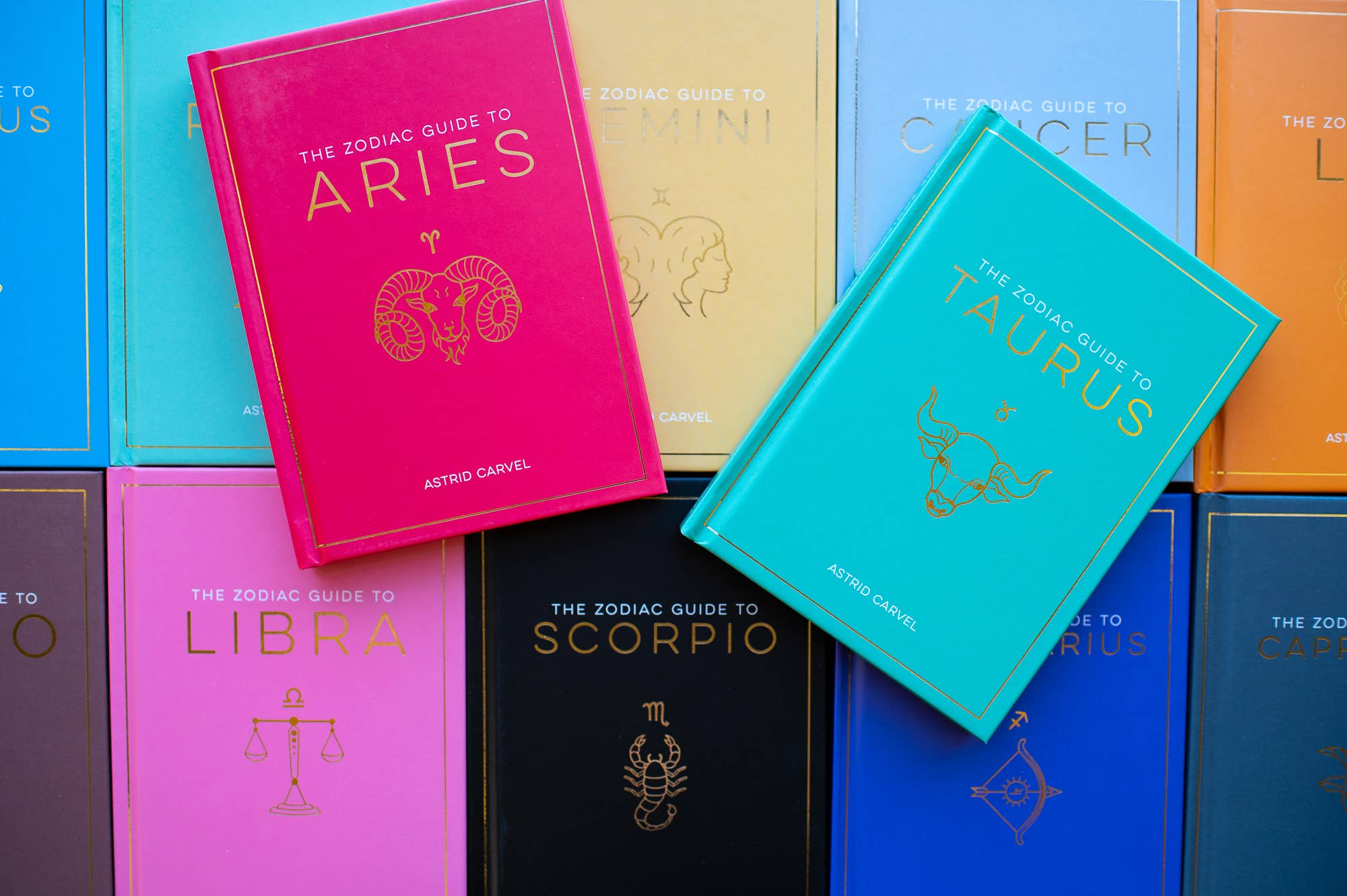 Colorful zodiac guide books stacked together