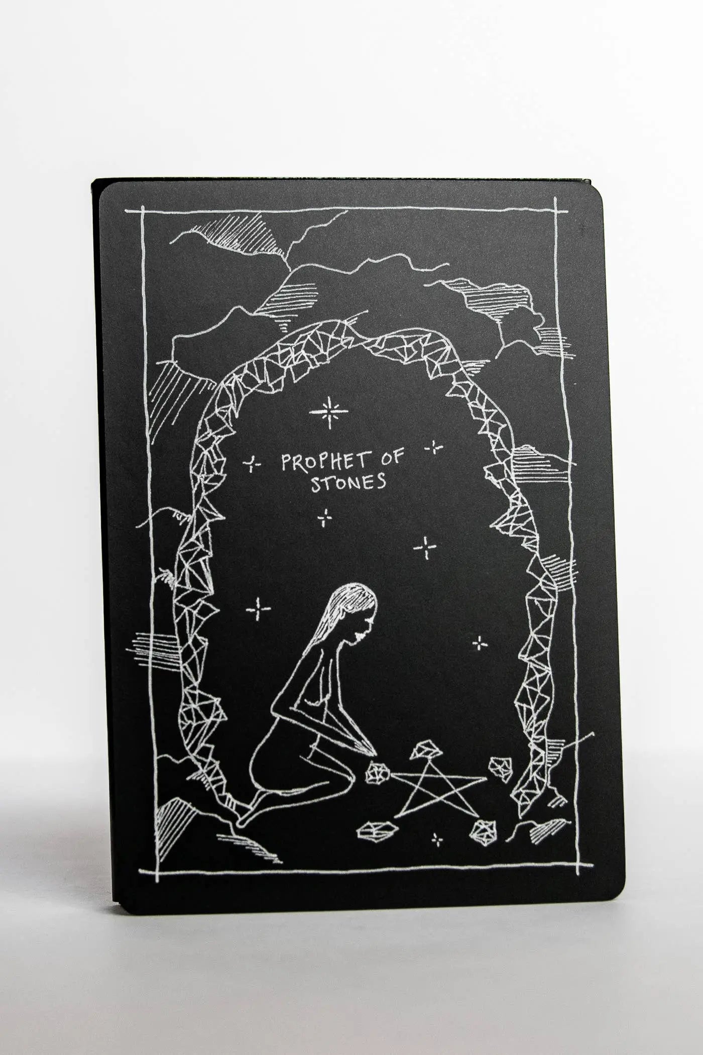 Black notebook with white illustrations and text on a white background