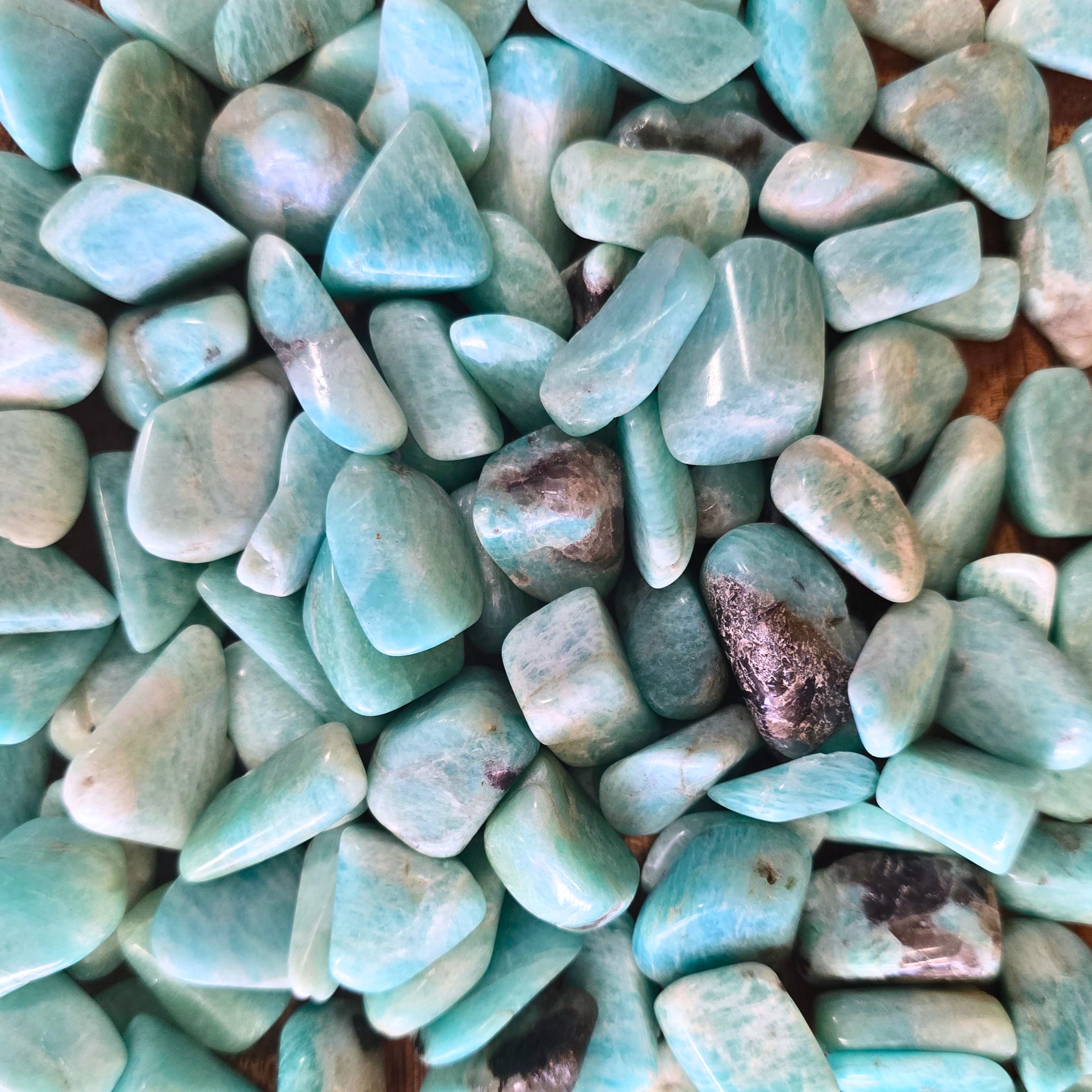 A pile of amazonite tumbles 