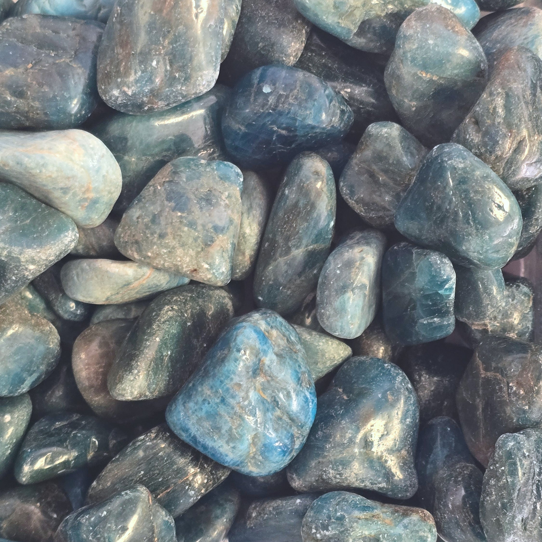 A pile of tumbled blue apatite crystals