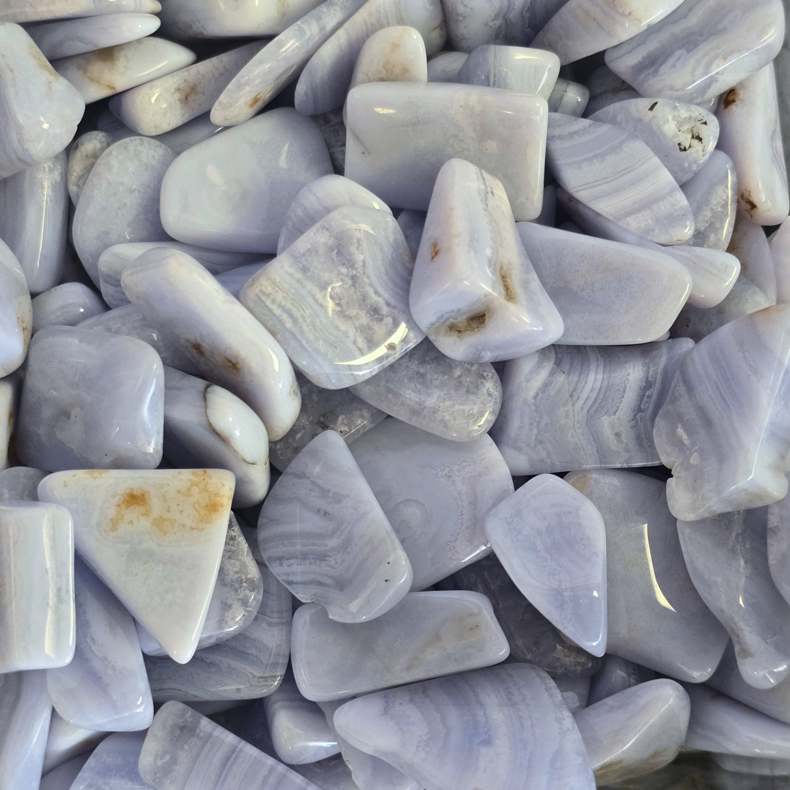 A pile of tumbled blue lace agate