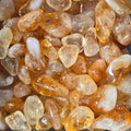 A pile of tumbled citrine