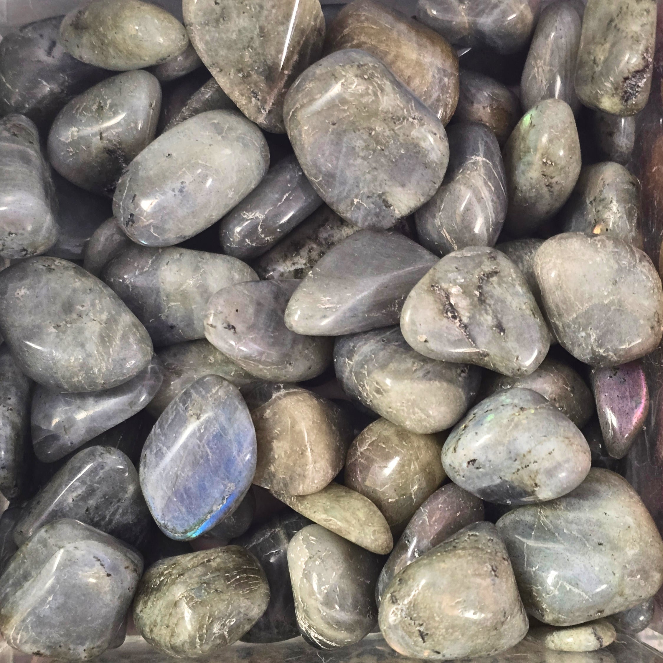 A pile of tumbled labradorite