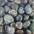 A pile of tumbled moss agate
