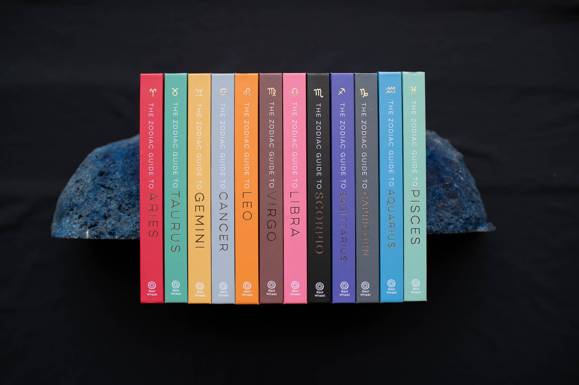 Set of books titled 'The Zodiac Guide to Astrology' by Astrid Carvel on a dark background.
