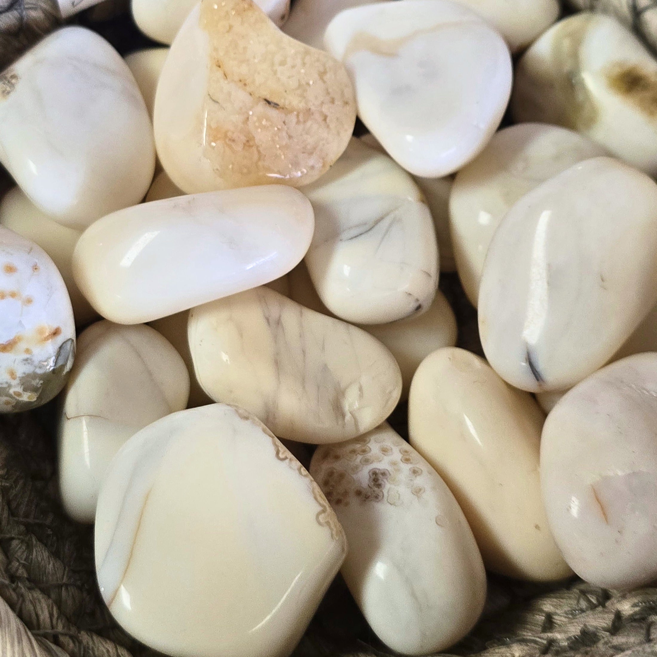 A pile of white opal tumbles 