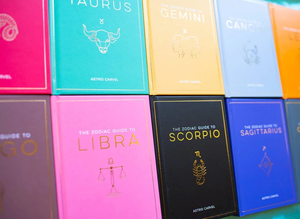 A collection of zodiac guidebooks displayed in a grid.